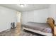Bedroom featuring wood-look flooring, a bed with comforter, and two doorways at 1981 N County Road 426, Oviedo, FL 32765