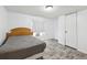 Bedroom showcasing wood-look flooring, bed with comforter, and a white door at 1981 N County Road 426, Oviedo, FL 32765