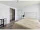 Bedroom with wood-look flooring, table and garment rack to the side of the bed at 1981 N County Road 426, Oviedo, FL 32765
