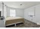 Bedroom with two windows, an air conditioner, and wood-look flooring at 1981 N County Road 426, Oviedo, FL 32765