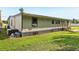 Home exterior featuring a side view and spacious green lawn at 1981 N County Road 426, Oviedo, FL 32765