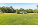 Large lot with a cozy home featuring a covered porch surrounded by green space at 1981 N County Road 426, Oviedo, FL 32765