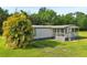 Lovely home featuring a covered porch and beautiful surrounding greenery at 1981 N County Road 426, Oviedo, FL 32765