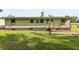 Home exterior displaying a side view, small porch, and green lawn at 1981 N County Road 426, Oviedo, FL 32765