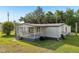 Charming home featuring a covered porch and lush green lawn at 1981 N County Road 426, Oviedo, FL 32765