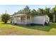 Cozy home boasting a covered porch and well-maintained lawn at 1981 N County Road 426, Oviedo, FL 32765