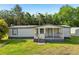 Charming home with a cozy porch and a well-maintained lawn at 1981 N County Road 426, Oviedo, FL 32765