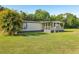 Inviting single-story home with a spacious front yard and covered porch at 1981 N County Road 426, Oviedo, FL 32765