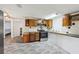 Kitchen boasts wooden cabinetry, and stainless steel appliances, ready for culinary adventures and Gathering meals at 1981 N County Road 426, Oviedo, FL 32765