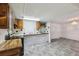 Functional kitchen with wood cabinets, stainless oven, and tiled backsplash; perfect for cooking and casual dining at 1981 N County Road 426, Oviedo, FL 32765
