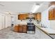 Kitchen features wood cabinets, modern oven, and adjacent dining area for seamless entertaining and everyday living at 1981 N County Road 426, Oviedo, FL 32765