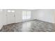 Bright living room with modern gray wood-look floors and fresh white walls at 1981 N County Road 426, Oviedo, FL 32765