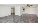Spacious living area with modern floors, opening to hallways and kitchen at 1981 N County Road 426, Oviedo, FL 32765