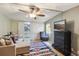 Comfortable main bedroom with a ceiling fan, sofa, and an ensuite bathroom enhancing privacy and convenience at 1981 N County Road 426, Oviedo, FL 32765