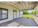 Covered front porch with neutral carpet and a view of the front yard at 1981 N County Road 426, Oviedo, FL 32765