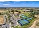 Expansive aerial view showcasing the community's amenities: pool, tennis courts, clubhouse, golf course, and beautiful landscaping at 2026 Key Bay Trl, Kissimmee, FL 34747