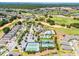 An aerial view showcasing the community's amenities including pool, tennis courts, golf course, and well-maintained landscaping at 2026 Key Bay Trl, Kissimmee, FL 34747