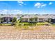The back exterior of the house features a well-manicured lawn, patio, and neutral paint at 2026 Key Bay Trl, Kissimmee, FL 34747