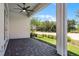 Covered patio with brick pavers, ceiling fan, and view of the backyard at 2026 Key Bay Trl, Kissimmee, FL 34747