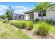 Exterior view of backyard featuring lawn, trees, covered patio, and lanai at 2026 Key Bay Trl, Kissimmee, FL 34747