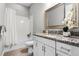 Bright bathroom featuring a shower, vanity, decorative mirror, and tiled floors at 2026 Key Bay Trl, Kissimmee, FL 34747