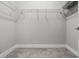Walk-in closet featuring an open space with shelves and carpet at 2026 Key Bay Trl, Kissimmee, FL 34747