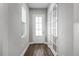 Home entryway featuring hardwood floors, glass doors, white trim and natural light at 2026 Key Bay Trl, Kissimmee, FL 34747