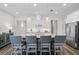 Modern kitchen with stainless appliances, white cabinets, an island with barstool seating and granite countertops at 2026 Key Bay Trl, Kissimmee, FL 34747