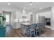 Modern kitchen with stainless appliances, gray cabinets, an island with barstool seating and granite countertops at 2026 Key Bay Trl, Kissimmee, FL 34747