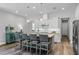 Modern kitchen with stainless appliances, white cabinets, an island with barstool seating and granite countertops at 2026 Key Bay Trl, Kissimmee, FL 34747