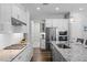 Bright kitchen features white cabinets, stainless steel appliances, granite countertops and wood flooring at 2026 Key Bay Trl, Kissimmee, FL 34747