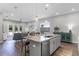 Modern kitchen with stainless appliances, white cabinets, an island with barstool seating and granite countertops at 2026 Key Bay Trl, Kissimmee, FL 34747