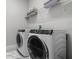 Laundry room showcasing a modern washer and dryer, complemented by wire shelving for storage at 2026 Key Bay Trl, Kissimmee, FL 34747