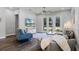 Spacious living room with french doors, hardwood floors, and a ceiling fan at 2026 Key Bay Trl, Kissimmee, FL 34747