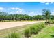Photo features a sprawling sand pit and beautiful trees against a bright blue sky with fluffy white clouds at 2026 Key Bay Trl, Kissimmee, FL 34747