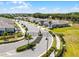 An exterior view features a gated entrance of a new home community with lush landscaping at 2026 Key Bay Trl, Kissimmee, FL 34747