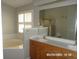 Bathroom boasting double vanity, jacuzzi tub, and framed mirror at 21708 Royal St Georges Ln, Leesburg, FL 34748