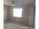 Inviting bedroom featuring ceiling fan, a window and closet at 21708 Royal St Georges Ln, Leesburg, FL 34748