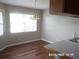 Bright dining area with hardwood floors, a window, and a traditional chandelier at 21708 Royal St Georges Ln, Leesburg, FL 34748