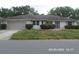 Charming single story home with a well-manicured front yard and attached garage at 21708 Royal St Georges Ln, Leesburg, FL 34748