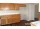 Well-lit kitchen with wooden cabinets and drawers, complemented by dark, attractive flooring at 21708 Royal St Georges Ln, Leesburg, FL 34748