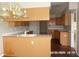 Open kitchen featuring light wood cabinets, a breakfast bar, and a view into another room at 21708 Royal St Georges Ln, Leesburg, FL 34748