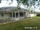 Large screened-in porch offering seamless indoor-outdoor living at 21708 Royal St Georges Ln, Leesburg, FL 34748