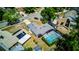 Aerial view of the home showcasing the screened in pool and lush landscaping at 2729 Hilda Ct, Orlando, FL 32826