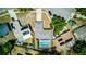 Aerial view of the home showcasing the screened in pool and lush landscaping at 2729 Hilda Ct, Orlando, FL 32826