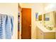 Bright bathroom with a gray vanity, mirror, and wooden door at 2729 Hilda Ct, Orlando, FL 32826