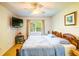 Comfortable bedroom featuring wood flooring, ceiling fan, and a large window at 2729 Hilda Ct, Orlando, FL 32826
