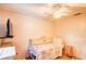 Cozy bedroom features a ceiling fan and a comfortable daybed with decorative pillows and bedding at 2729 Hilda Ct, Orlando, FL 32826