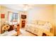 Bright bedroom with a bed, desk, shelving, and ceiling fan at 2729 Hilda Ct, Orlando, FL 32826