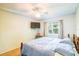 Cozy bedroom features a ceiling fan, TV, and window with natural light at 2729 Hilda Ct, Orlando, FL 32826